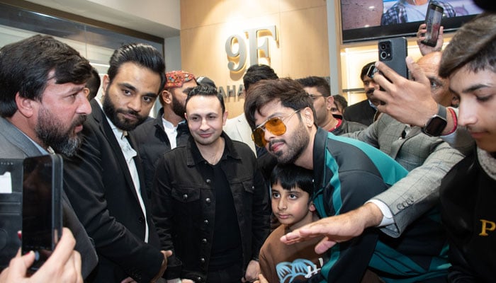 In this image, actor Fahad Mustafa (rght) takes a picture with a child during a ceremony on December 14, 2024. — Facebook@thecentaurusmall