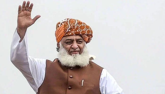 Jamiat Ulema-e-Islam-Fazl (JUI-F) Chief Maulana Fazlur Rehman waves to the crowd at a public gathering in this undated image. — AFP/File