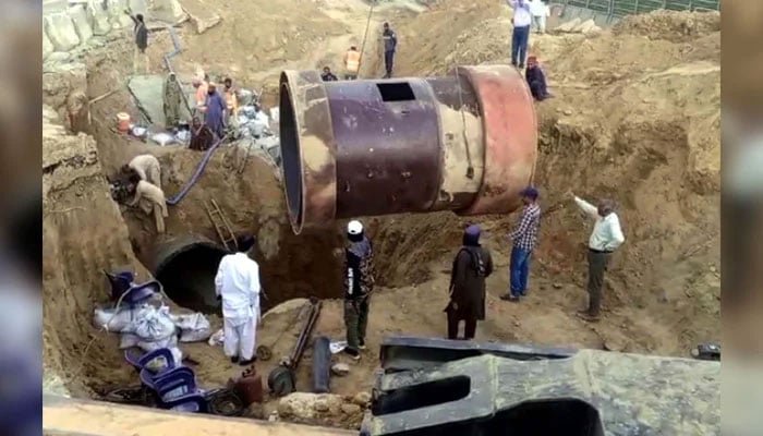 Repair work of broken water pipeline underway at University Road in Karachi on December 8, 2024. — PPI