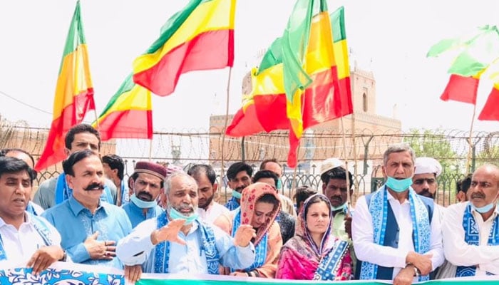 In this representational image activists and supporters of the Pakistan Seraiki Party hold flags in a rally. — Facebook@malikallahnawazwainspresident/File