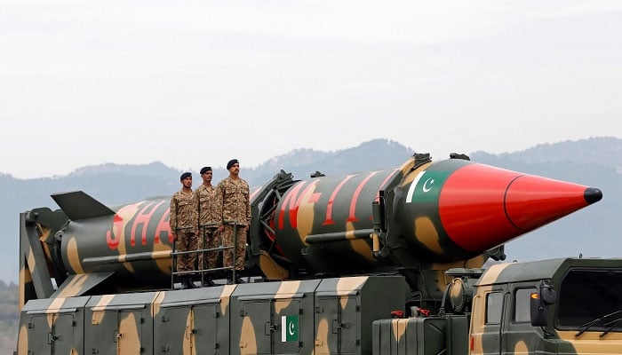 Military personnel stand beside a Shaheen III surface-to-surface ballistic missile during Pakistan Day military parade in Islamabad on March 23, 2019.— Reuters