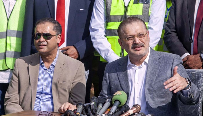 Sindh Senior Minister Sharjeel Inam Memon (right) addresses media persons after inspecting the construction work on the Yellow Line BRT bus depot, at the Korangi area of Karachi on December 18, 2024. — PPI