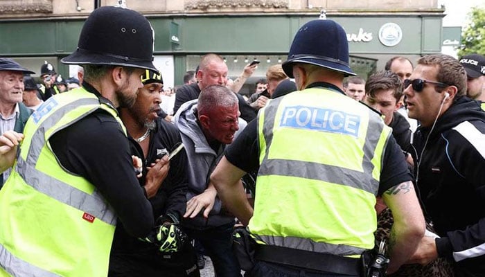 Protesters and counter-protestors scuffle in Nottingham, central England, on August 3, 2024 during the Enough is Enough demonstration held in reaction to the fatal stabbings in Southport on July 29.— AFP