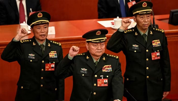 Then-Defense Minister Li Shangfu (right) raises a fist with other Chinese military leaders as they swear an oath at a National Peoples Congress session in Beijing in March 2023.— Reuters/File