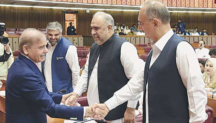 PM Shehbaz Sharif greets PTI leaders Omar Ayub and Asad Qaiser during National Assembly proceedings.— Facebook@National Assembly of Pakistan/File