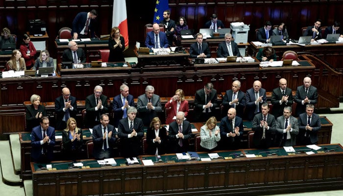 Members of the government applaud the speech of Italys Prime Minister Giorgia Meloni during a session at the lower house of parliament in Rome, Italy, December 17, 2024. — Reuters