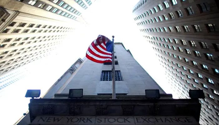 A flag flies at the exterior of New York Stock Exchange on June 15, 2012. — Reuters