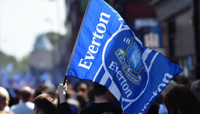 A person flattering flag of Premier League club Everton. — AFP/File