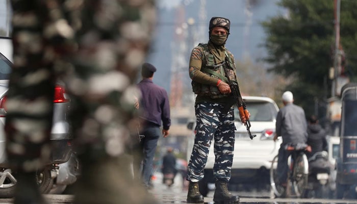 Indian Central Reserve Police Force (CRPF) personnel stand guard on a street in Srinagar, October 12, 2021. — Reuters