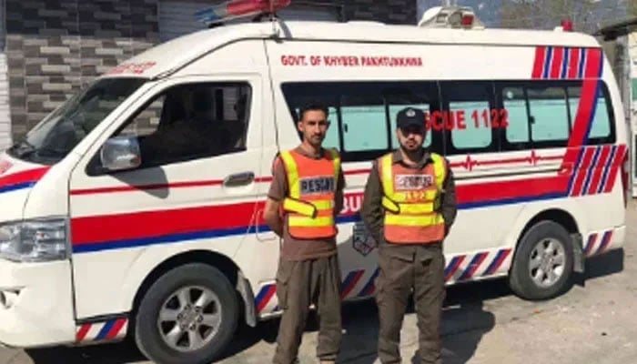 This representational image shows Rescue 1122 officials standing near an ambulance. — Facebook@Swat Emergency Rescue Service 1122/File