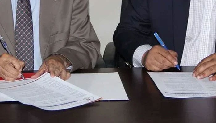 This representational image shows officials signing a MOU during a signing ceremony. — APPNA Website/File