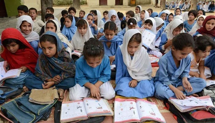 The representational image shows students attending a school in KP. — AFP/File