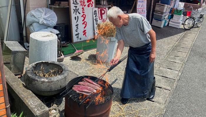 Fishmonger Yasushi Miyamoto, 70, prepares local delicacy, bonito seared over a hay fire, in Ino, Kochi Prefecture, Japan, August 10, 2024. — Reuters