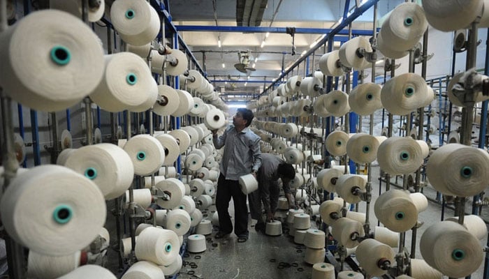 In this image, a man can be seen working in a textile factory in Pakistan. — AFP/File