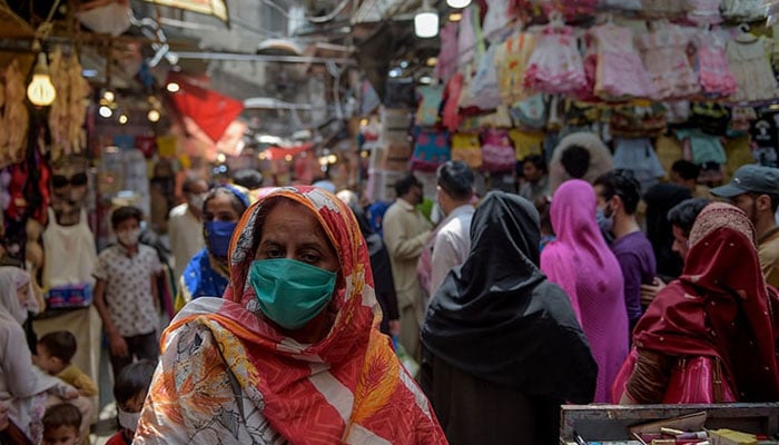 Women shop at a market after in Rawalpindi on May 9, 2024. — AFP