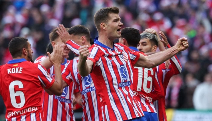 Atletico Madrids Norwegian forward Alexander Sorloth (right) celebrates after scoring their first goal between Club Atletico de Madrid and Getafe CF at the Metropolitano stadium in Madrid on December 15. — AFP