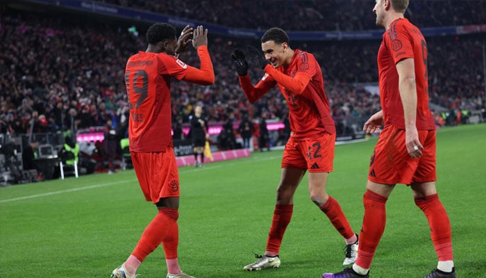 Alphonso Davies (left) celebrates his goal with Jamal Musiala and Harry Kane. —AFP/File