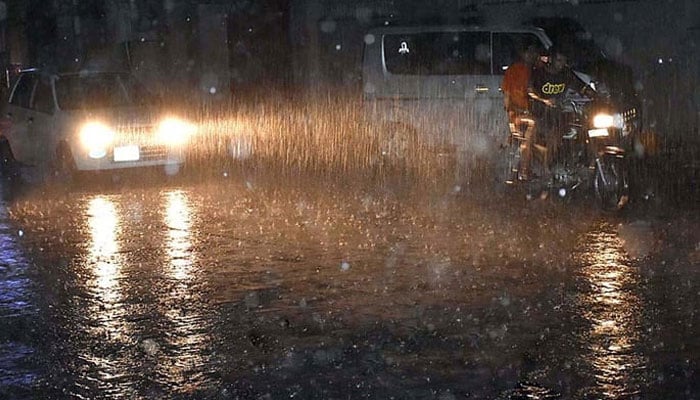 People commuting during heavy rain in Sialkot, on June 25, 2023. — APP