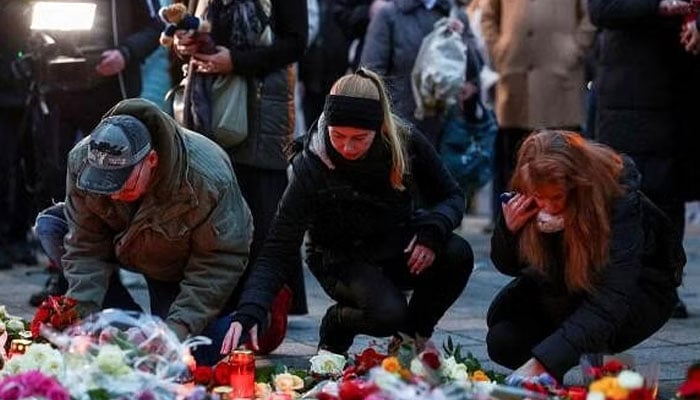 People lay candles and tributes at the site where a car drove into a crowd at a Magdeburg Christmas market in Magdeburg, Germany. —Reuters/File