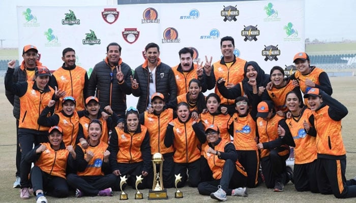 Conquerors pose for a group photo with the National Women’s One-Day Tournament trophy. — PCB/File