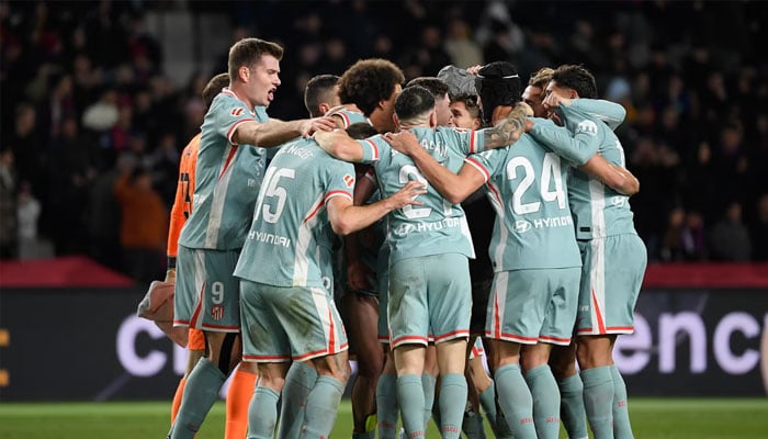 Atletico Madrid players celebrate after scoring their second goal during the Spanish league football match between FC Barcelona and Club Atletico de Madrid on December 21, 2024. —AFP