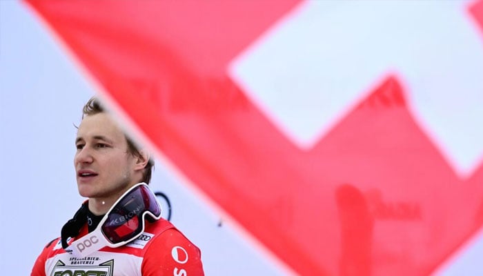 Marco Odermatt stands on the top step of the podium after winning the Alta Badia mens giant slalom to set a Swiss record. —AFP/File