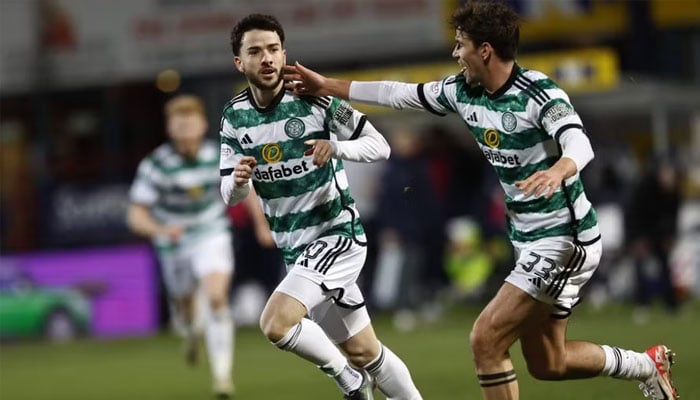 Mikey Johnston celebrates scoring Celtics second goal against Dundee. — AFP/File