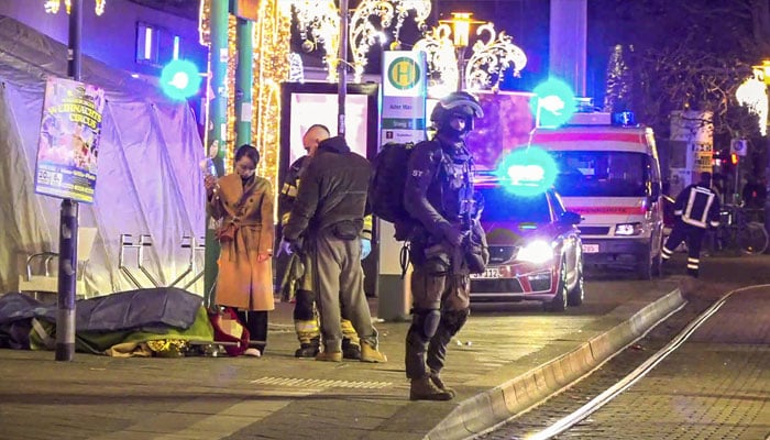 Police and emergency services at the site of the deadly attack on Friday night. —AFP/File