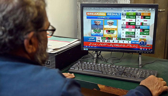 A man watching latest election results live streaming on Geo News on a computer screen in this undated photo. — APP/File