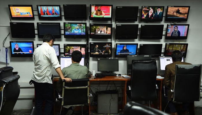 A representational image showing Afghan reporters inside a newsroom in Kabul on September 11, 2018. —AFP