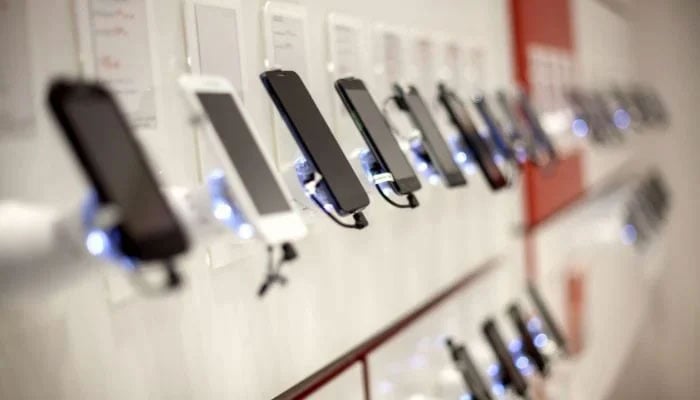 A representational image of mobile phones on display at a mobile phone store. — Unsplash/File