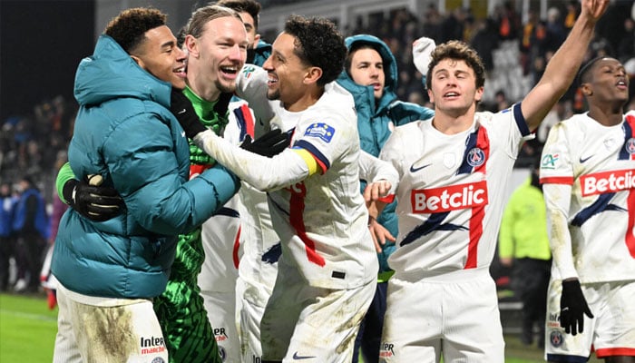 PSG players celebrate with goalkeeper Matvey Safonov after he helped them beat Lens on penalties in the French Cup on Sunday. —AFP/File