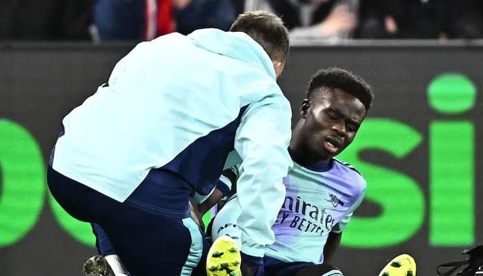 Arsenals Bukayo Saka receives medical attention after sustaining an injury. —Reuters/File