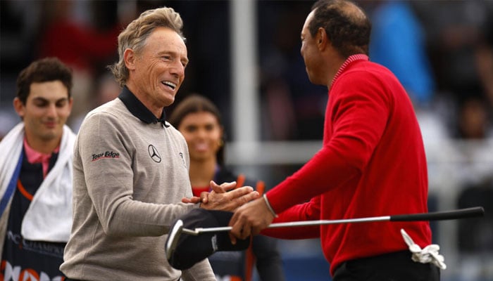 Tiger Woods and Bernhard Langer shake hands after Team Langers victory over Team Woods in the PNC Championship family golf event. —AFP/File