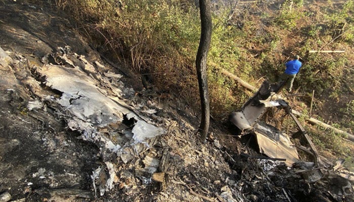 A resident looks at the site where a Cessna 207 plane crashed in Santa Maria del Oro, Jalisco state, Mexico on December 22, 2024.—AFP