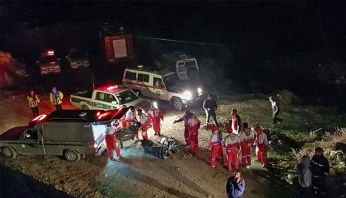 This handout picture provided by the Iranian Mizan News Agency on January 9, 2020 shows Iranian Red Crescent paramedics recovering bodies at the scene of a bus accident that plunged off a mountain road into a ravine in Mazandaran province. — AFP/File