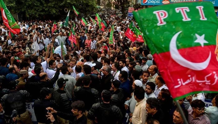 Activists of PTI protest on a street on October 21, 2022. — AFP