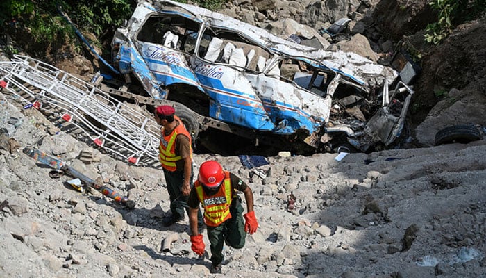 Rescue personnel inspect the site of a bus accident that killed 23 people after it plunged into a ravine at Soon village near Kahuta, Punjab province on August 25, 2024. — AFP/File