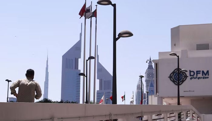 A person runs outside the Dubai Financial Market building in Dubai, United Arab Emirates, March 20, 2023. — Reuters