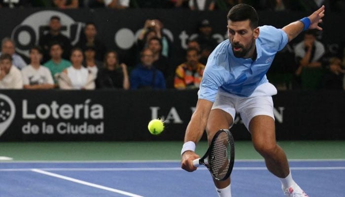 Serbias Novak Djokovic returns the ball during Argentinas Juan Manuel del Potros farewell exhibition tennis match at Arena Parque Roca in Buenos Aires on December 1, 2024.— AFP