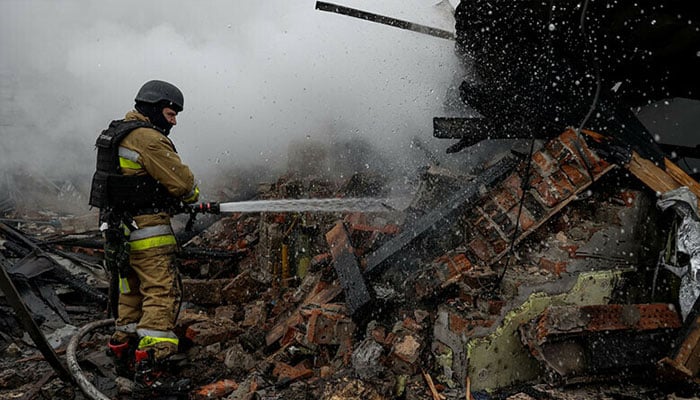 A firefighter works at the site of residential buildings hit by a Russian drone strike in Kharkiv, Ukraine on December 25, 2024. — Reuters