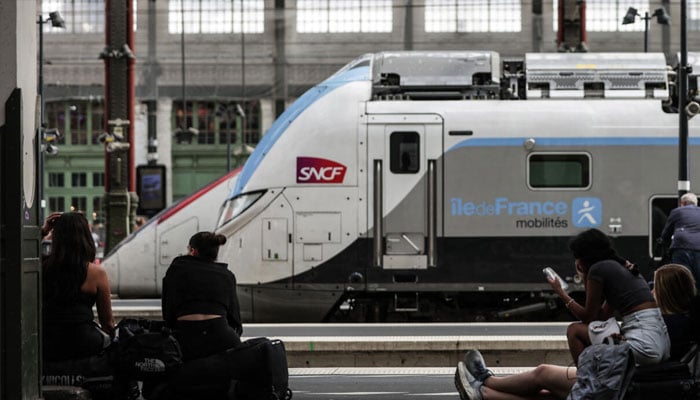 Passengers wait for their train departures on a platform at Gare de Lyon train station in Paris, on July 31, 2024. —AFP