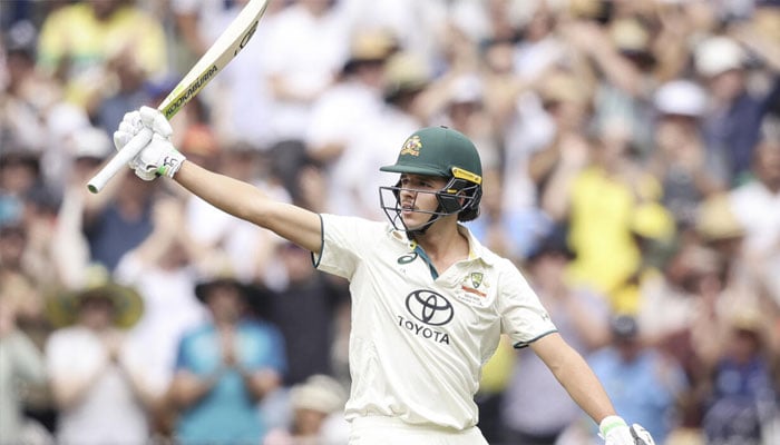 Australias Sam Konstas raises his bat after passing 50 on day one of the fourth Test against India.— AFP/File