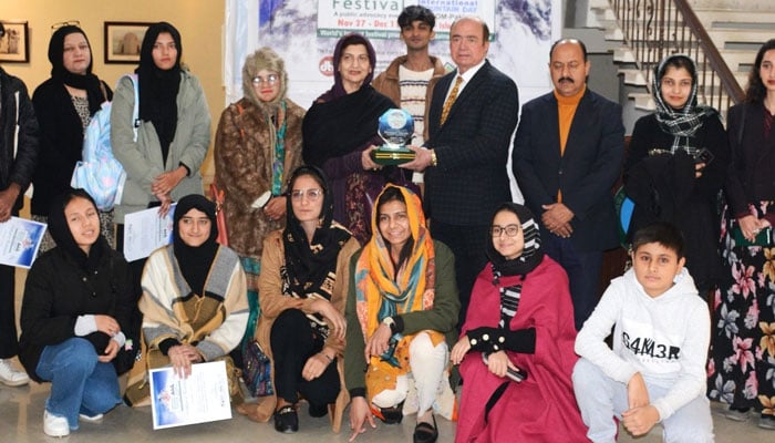 Group photo at a painting exhibition titled ‘Mountain Heritage and Landscape’ jointly organised by the Punjab Arts Council (PAC) Rawalpindi and Devcom-Pakistan at the Rawalpindi Arts Gallery, on Dec 26, 2024. — Facebook@pucarofficialpage.