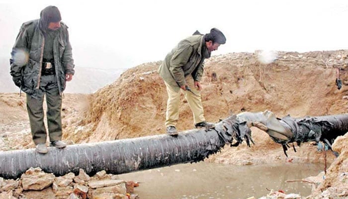 The representational image shows lawenforcers inspecting a blown up gas pipeline in Balochistan. — APP/File