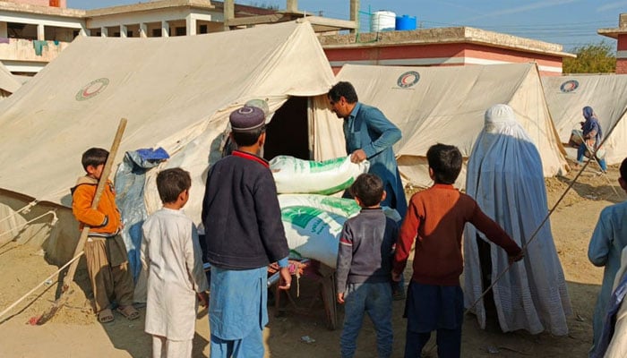 Flour bags being distributed by King Salman Humanitarian Aid and Relief Centre. — Radio Pakistan/File