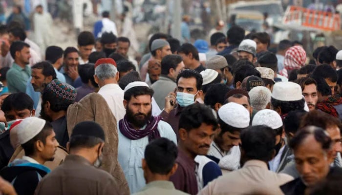 A crowd of people along a makeshift market in Karachi. — Reuters/File