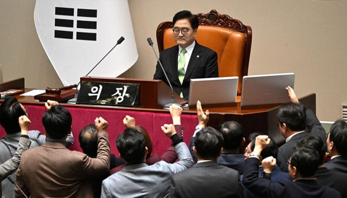 South Korean lawmakers chanting slogans in front of acting President Han Duck-soo. — AFP/File