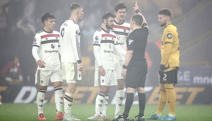 Bruno Fernandes (centre) being sent-off in Manchester Uniteds 2-0 defeat at Wolves. — AFP/File