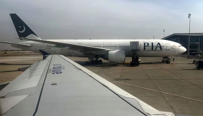 View of a Pakistan International Airlines (PIA) passenger plane, taken through a glass panel, at Islamabad International Airport, Pakistan October 3, 2023. — Reuters